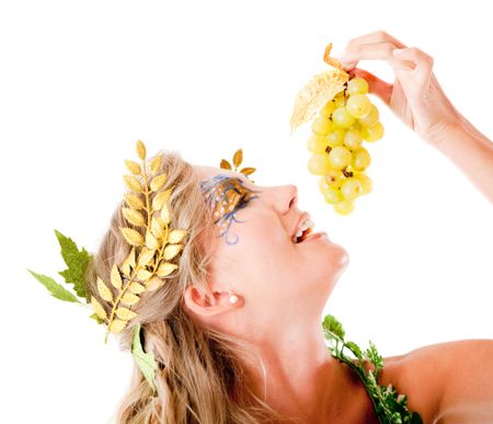 Beautiful Greek goddess eating a bunch of grapes - isolated