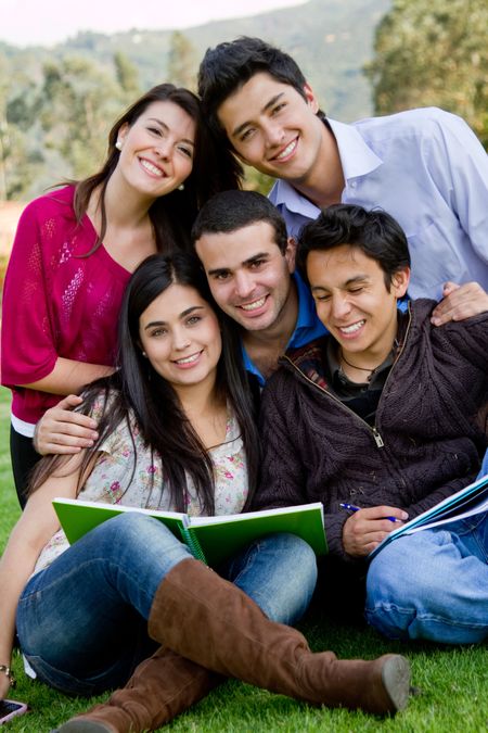 Group of students with a notebook outdoors