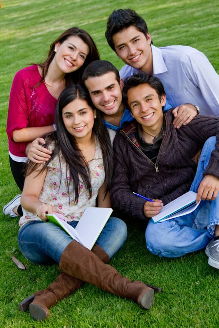 Group of students with notebooks studying outdoors