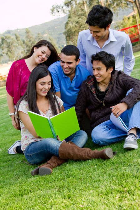 Group of students with a notebook outdoors