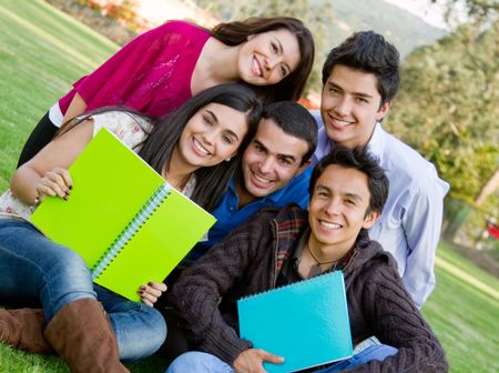 Group of students with notebooks studying outdoors