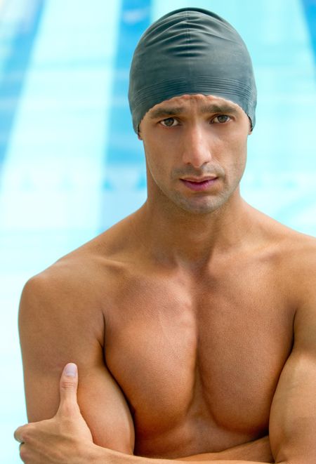 Male swimmer wearing a swimming hat at the pool