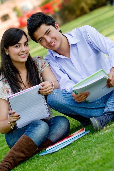 Couple of students sitting outdoors and talking