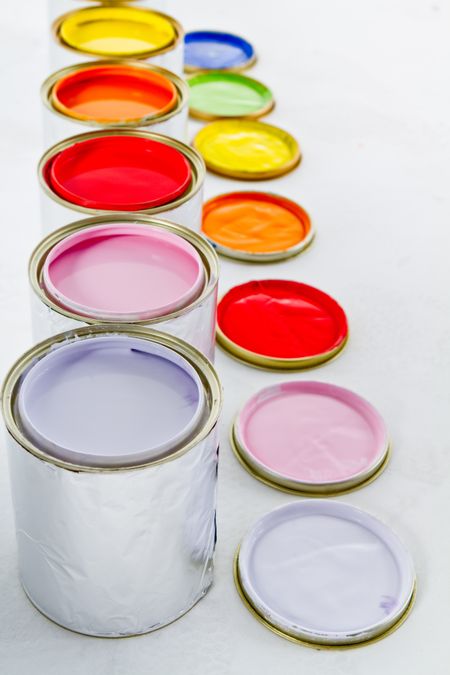 Paint cans on different colors - isolated over white