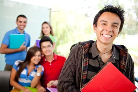 Male student at the university with a group of people behind