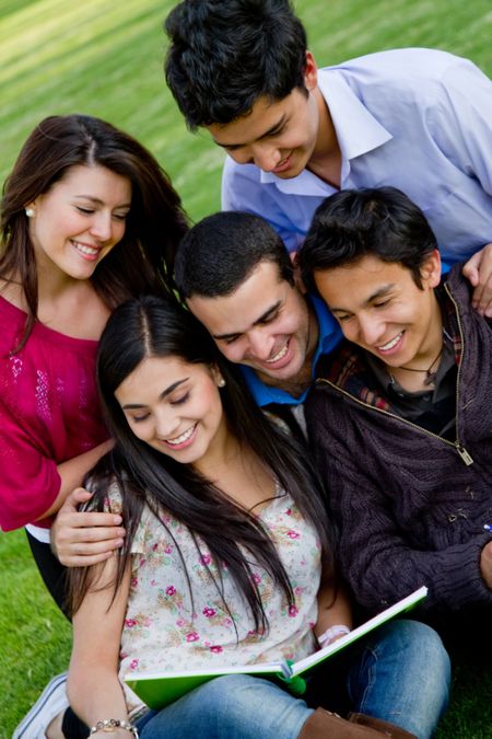 Group of students with a notebook outdoors