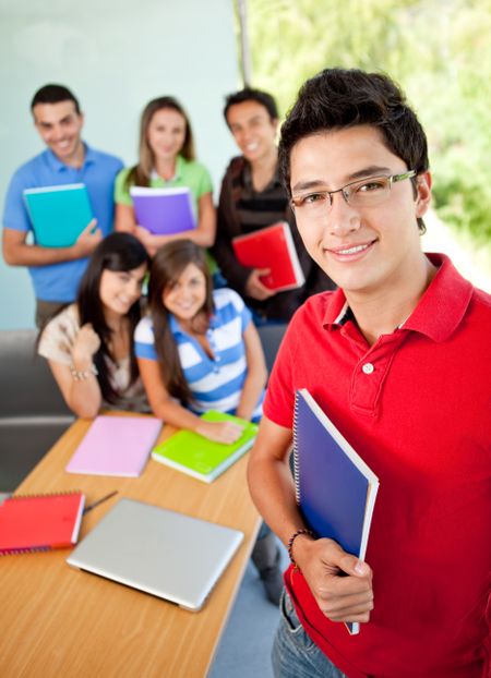 Male student at the university with a group of people behind