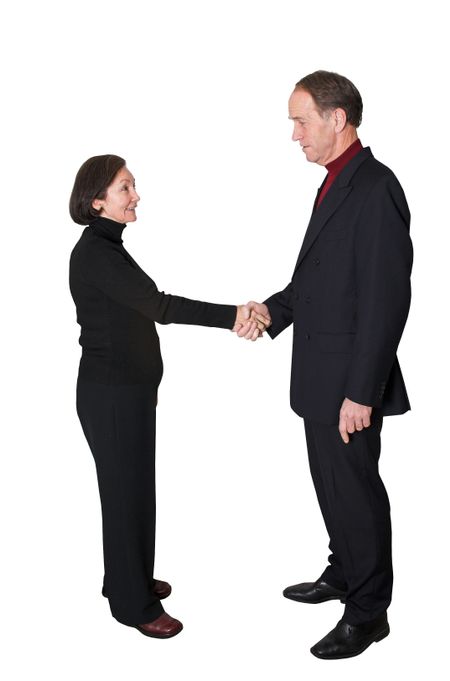 business couple shaking hands over a white background