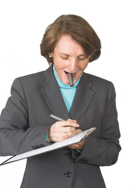 business woman taking notes on a folder with her pen top on her mouth