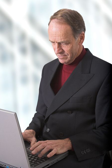 Business man on a laptop in his own office