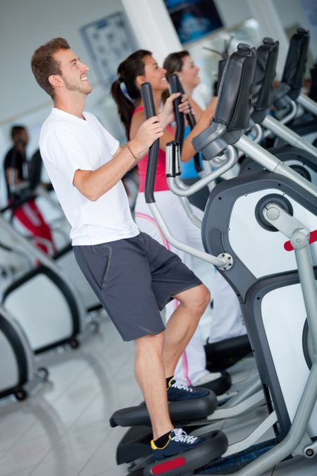 Group of people at the gym exercising on the xtrainer machines