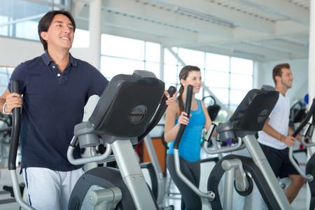 Group of people at the gym exercising on the xtrainer machines