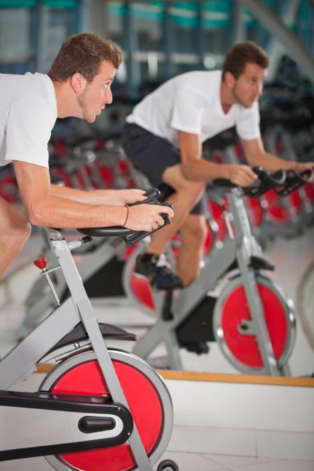 Athletic man on excercise bike at the gym