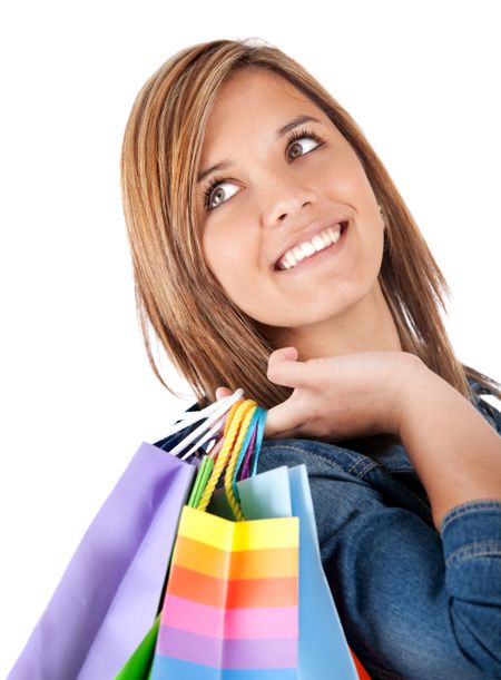 Teenage shopping girl holding bags - isolated over a white background