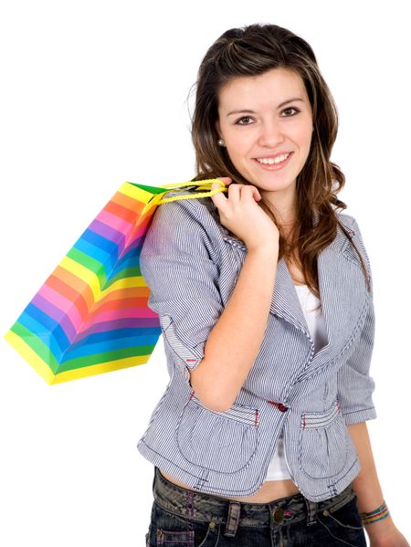 girl smiling and carrying shopping bags isolated over a white background