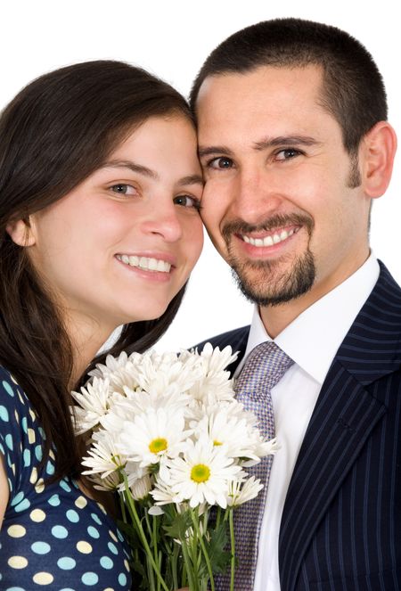 couple of young people portrait smiling and holding flowers - isolated over a white background
