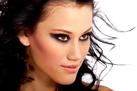 beautiful fashionable face with outstanding eyes and heavy makeup - isolated over a white background