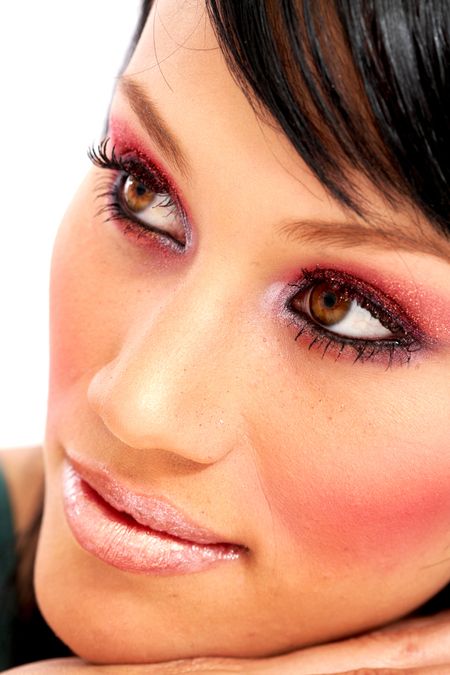 beautiful fashionable face with outstanding eyes and heavy makeup - isolated over a white background