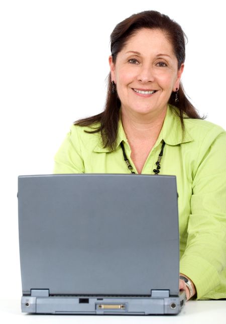 friendly senior woman smiling while working on a laptop computer isolated over a white background