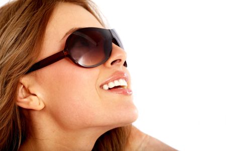 fashion or casual woman portrait wearing sunglasses giving a big smile - isolated over a white background