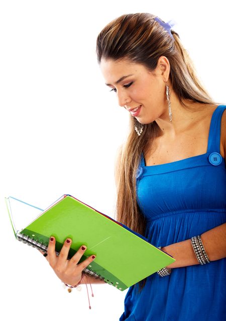 college student reading a green notebook isolated over a white background