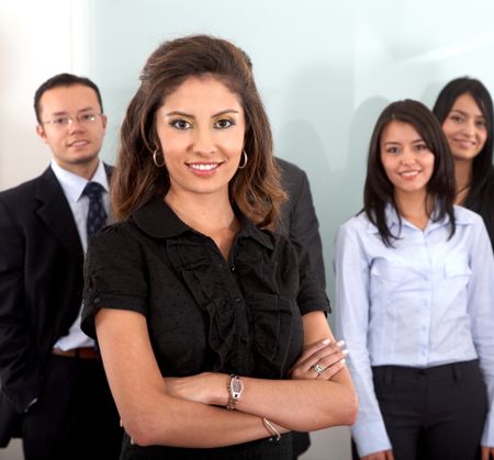Business team in an office with a businesswoman leading