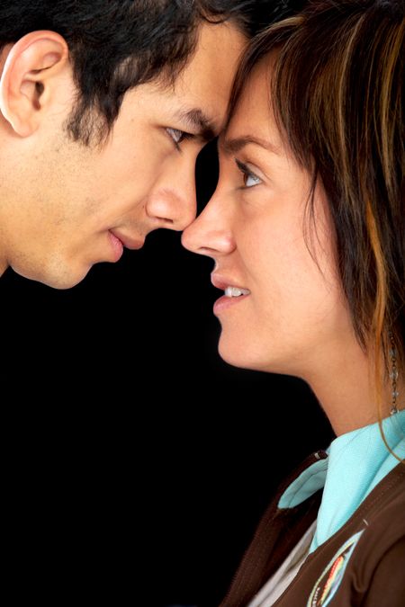 couple of lovers in love face to face - isolated over a black background