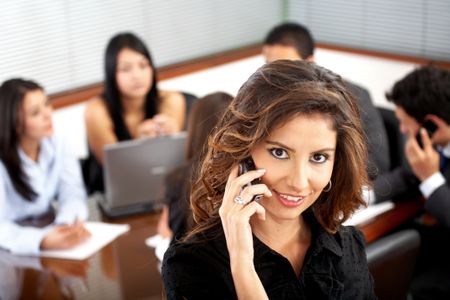 business woman on the phone during an office meeting