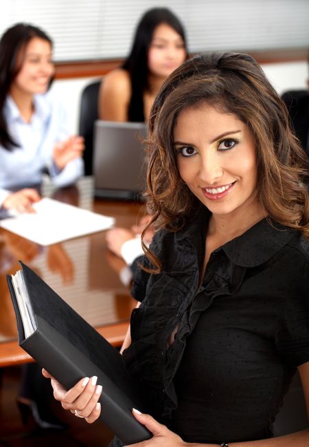 Business woman portrait smiling in an office - hispanic