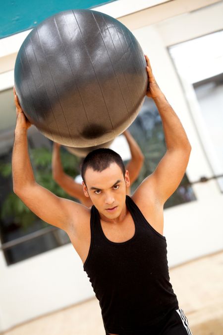 fitness male doing pilates exercises at the gym