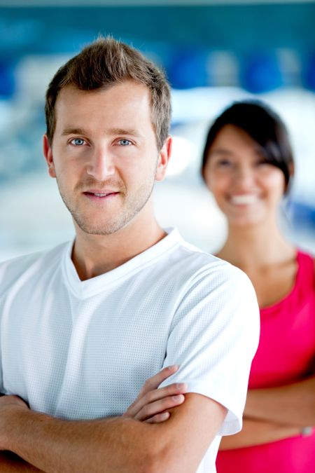 Young couple of people smiling at the gym