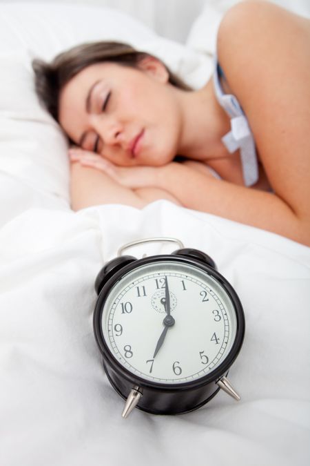 Beautiful woman sleeping in her bed until 7 o?clock