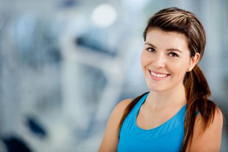 Beautiful athletic woman at the gym smiling