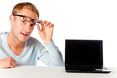 Surprised man with a laptop and glasses ? isolated over white