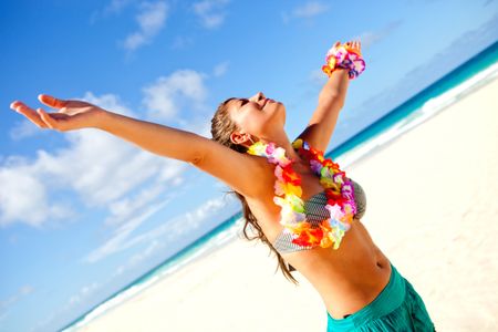 Hawaiian woman relaxing at the beach with arms open