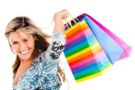 Happy shopping woman holding bags - isolated over a white background
