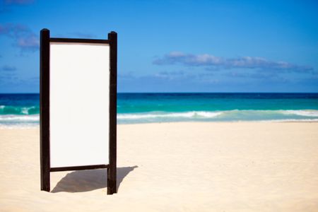 Blank banner buried in sand at the beach - to add your text