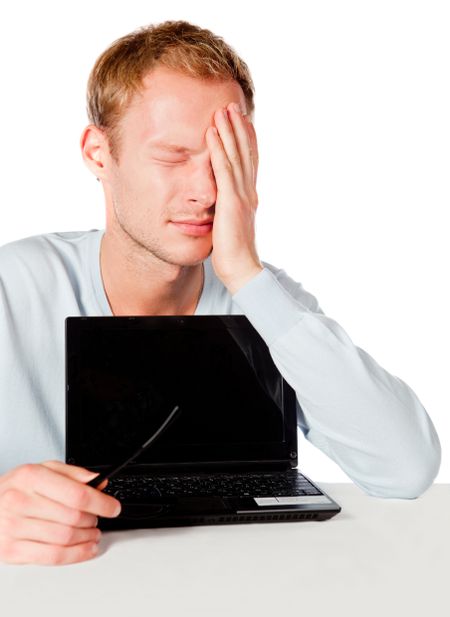 Upset man having technical problems with a laptop computer - isolated