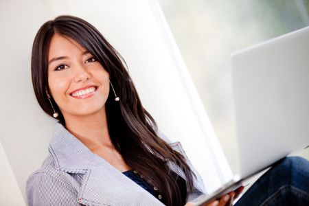 Woman working on a laptop computer at home