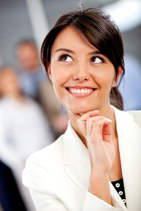 Thoughtful business woman portrait smiling at the office