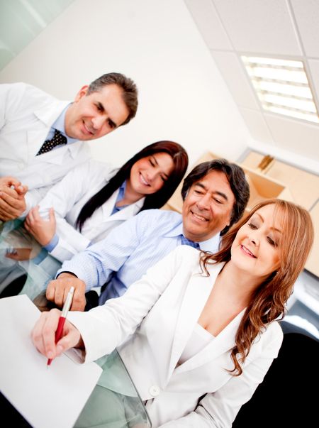 Business people in meeting with doctors signing a contract on medical insurance