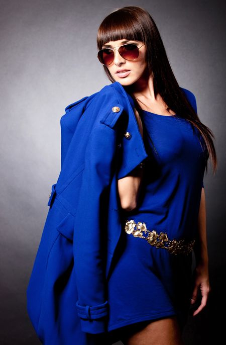 Fashion woman in blue holding a coat