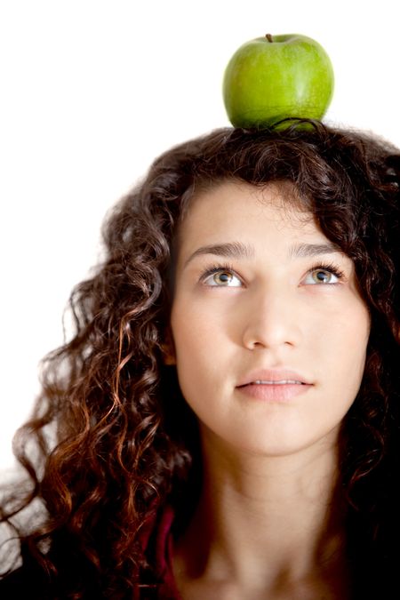 Woman portrait thinking organic with an apple on her head - isolated