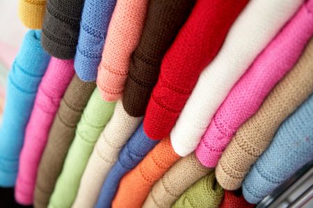 colourful clothes stacked in a retail store - woolen jumpers