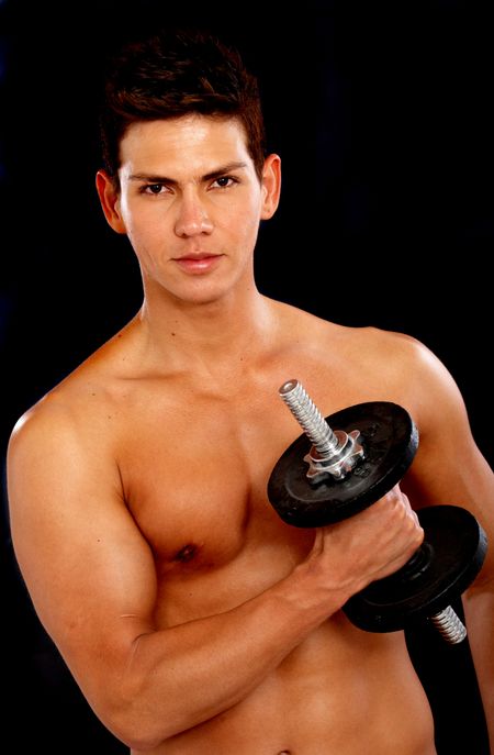fitness male doing free weights exercises over a black background
