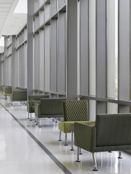 Chairs in pairs by windows along "lounge lane" of hallway at community college
