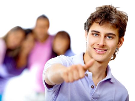 Young man with thumbs up and a group behind - isolated over a white background