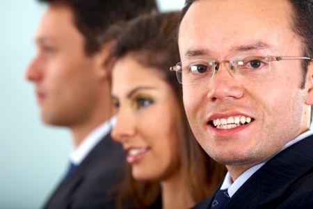 confident business man with glasses in an office smiling