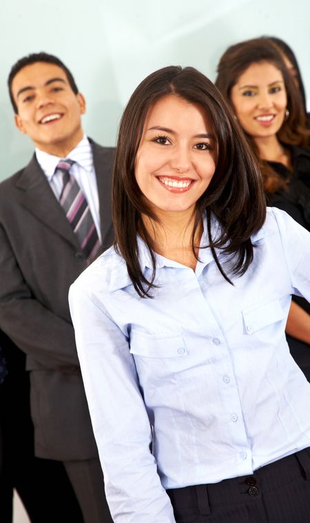 Business woman in front of a team in an office