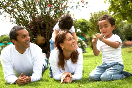 family lifestyle portrait of a mum and dad with their two kids having fun outdoors